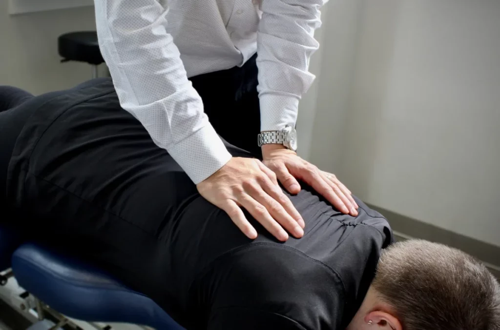 a spinal adjustment performed on a patient by a chiropractor at ICE