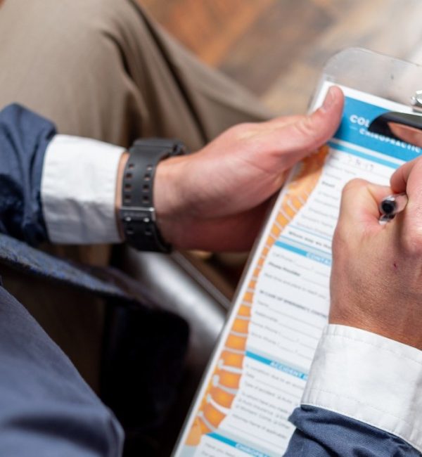 A new patient at ICE fills out paperwork